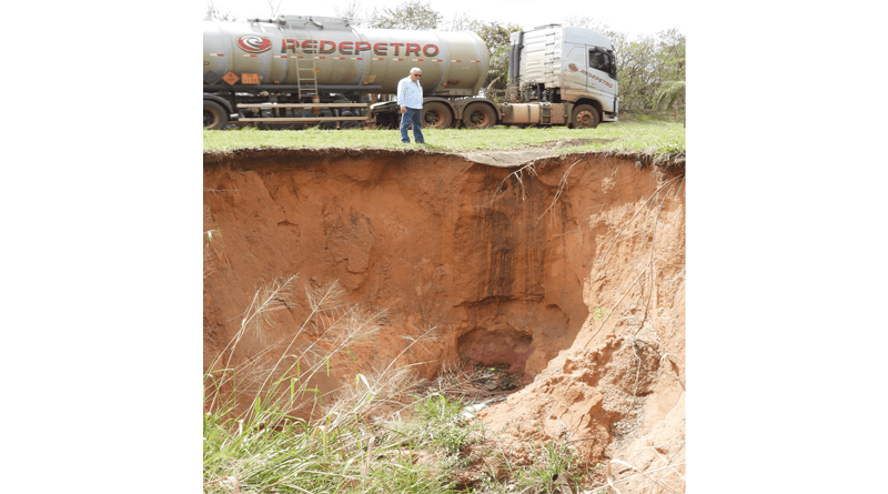 À esquerda, percebe-se claramente a proporção da profundidade da erosão, e o pequeno espaço entre o barranco e o caminhão que trafegava no instante da foto.